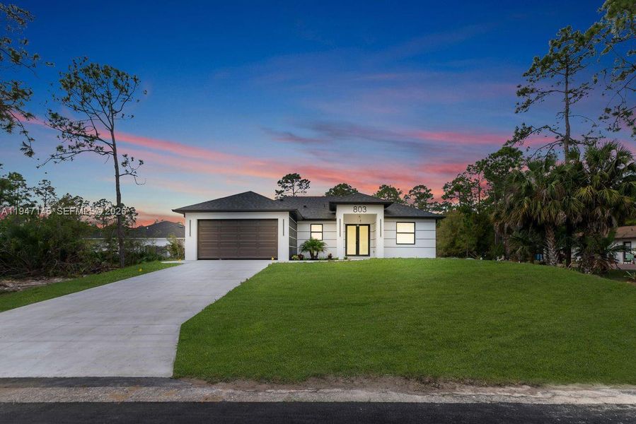 Front exterior of a new home in , Lehigh Acres, FL, highlighting curb appeal (Image 19).