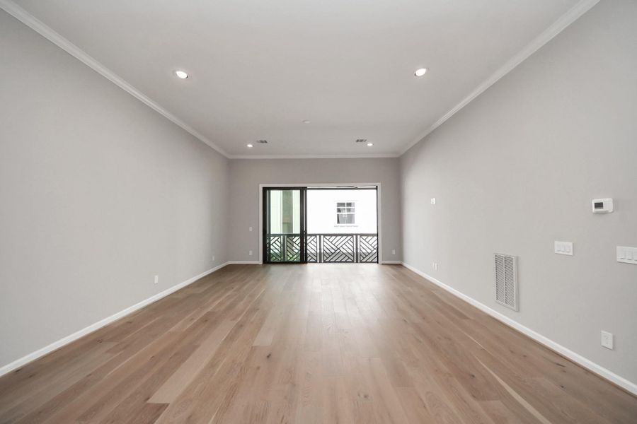 Open-concept living area with engineered wood flooring and abundant natural light. Open-concept living area with engineered wood flooring and abundant natural light.