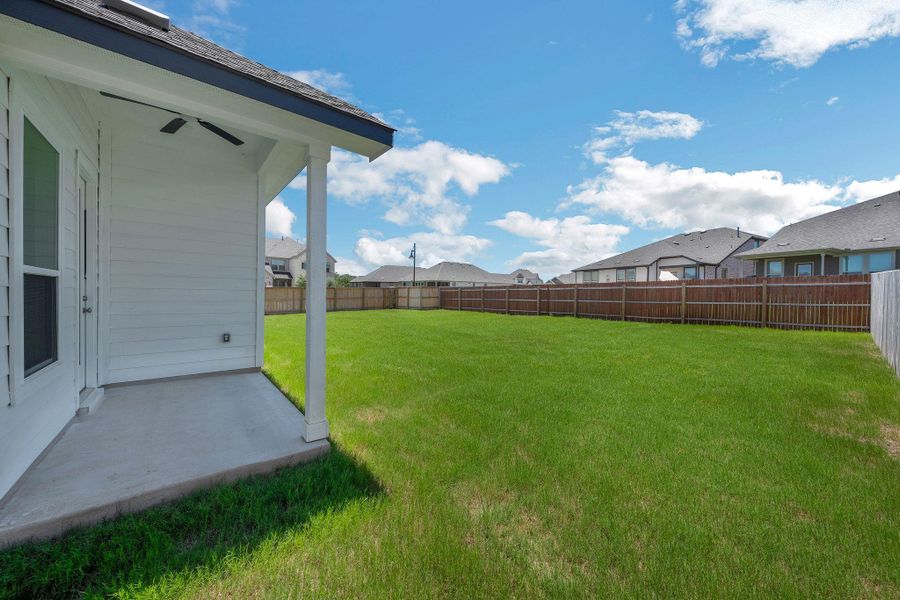 Fenced backyard featuring a residential view and a patio