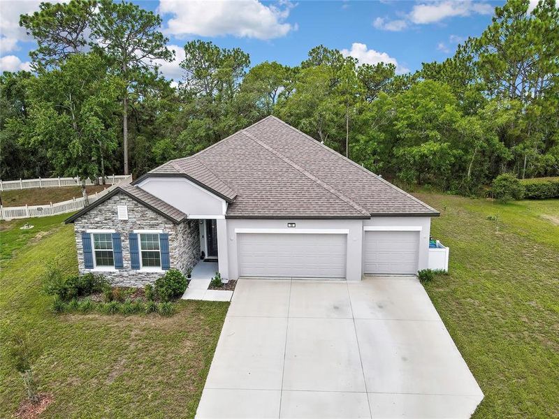 Front exterior of a new home in , Homosassa, FL, highlighting curb appeal (Image 25). Front exterior of a new home in , Homosassa, FL, highlighting curb appeal (Image 25).
