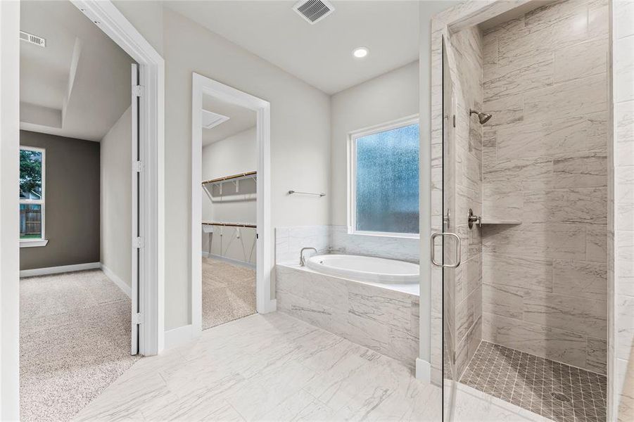 Another View of the Primary Bathroom with Tile to the Ceiling in the Shower.