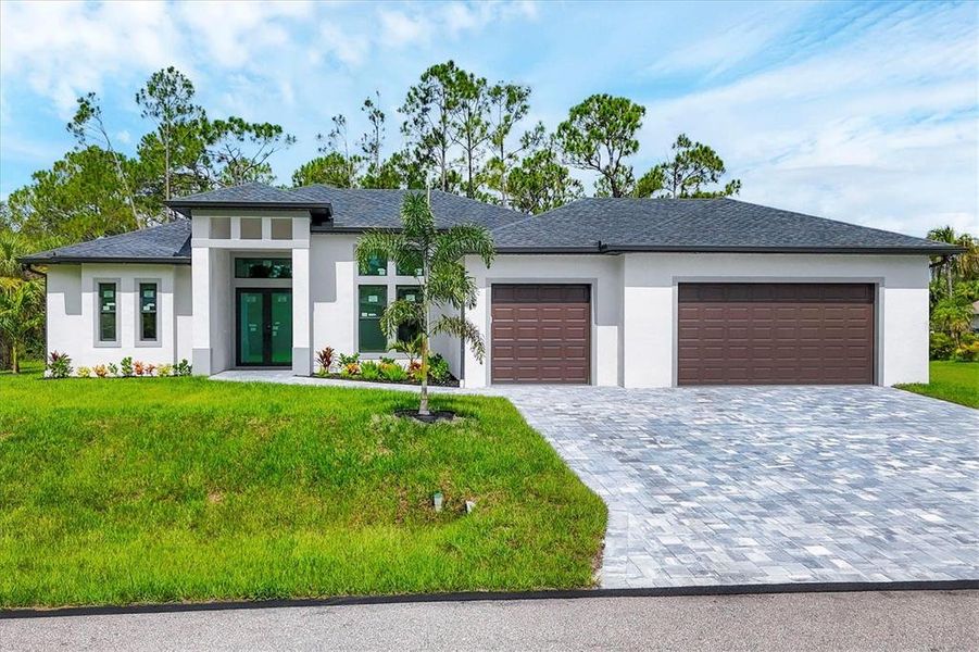 Front exterior of a new home in , North Port, FL, highlighting curb appeal (Image 1). Front exterior of a new home in , North Port, FL, highlighting curb appeal (Image 1).