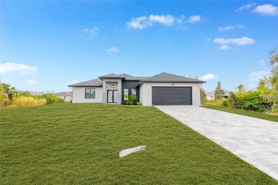 Front exterior of a new home in , Lehigh Acres, FL, highlighting curb appeal (Image 1).