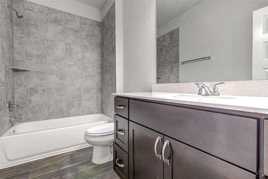A well-appointed bathroom with contemporary fixtures and durable wood-look flooring. A well-appointed bathroom with contemporary fixtures and durable wood-look flooring.