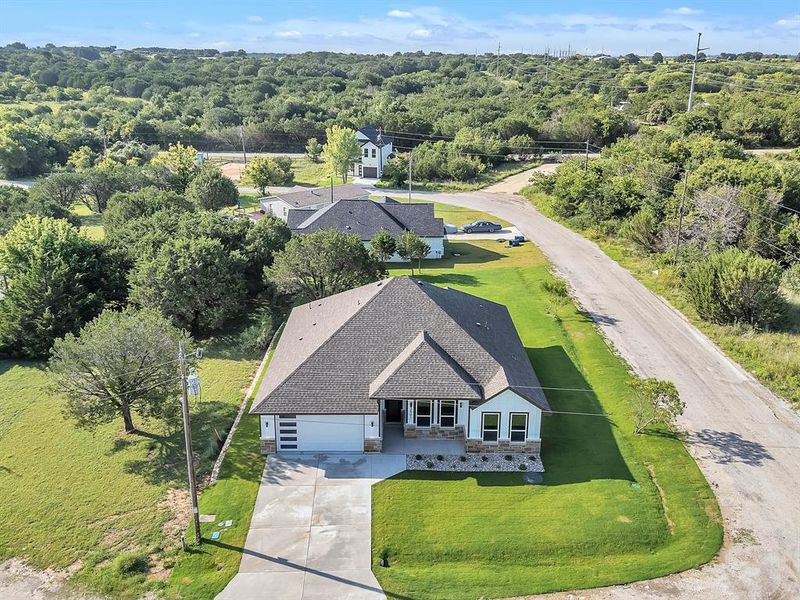 Front exterior of a new home in , Granbury, TX, highlighting curb appeal (Image 24). Front exterior of a new home in , Granbury, TX, highlighting curb appeal (Image 24).