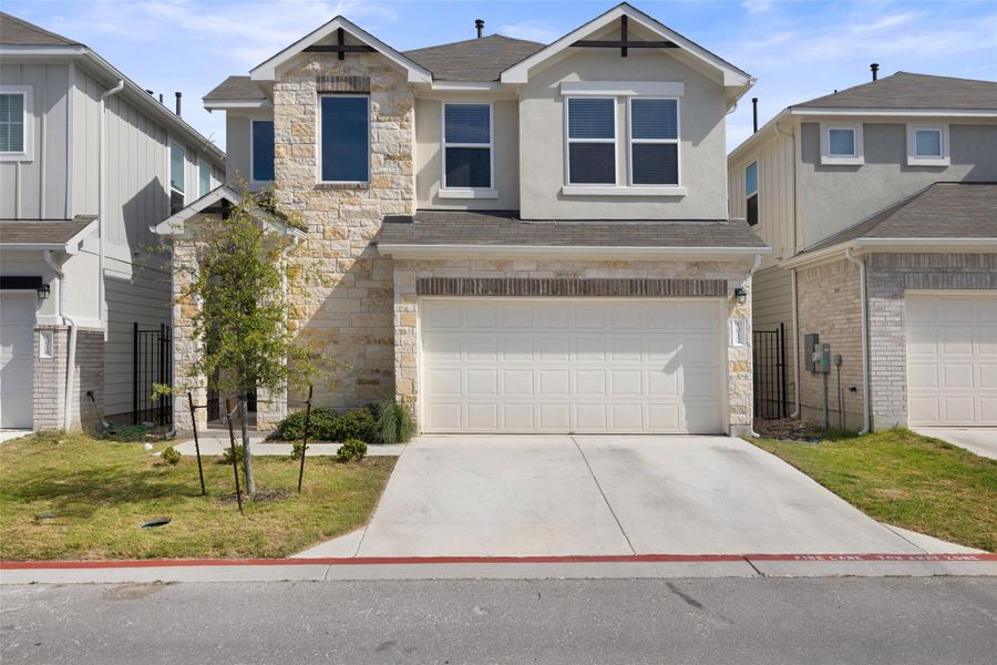 Front exterior of a new home in Messinger Village, Austin, TX, highlighting curb appeal (Image 20).