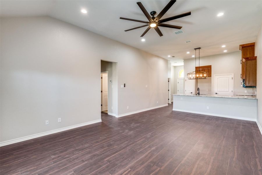 Unfurnished living room with recessed lighting, dark wood-style floors, and ceiling fan Unfurnished living room with recessed lighting, dark wood-style floors, and ceiling fan