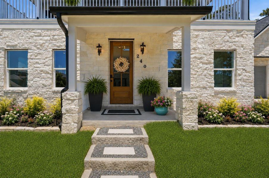 Impressive custom design elements are evident from every angle including the beautiful stone fascia, upstairs balcony, and a lot that sits elevated. Impressive custom design elements are evident from every angle including the beautiful stone fascia, upstairs balcony, and a lot that sits elevated.