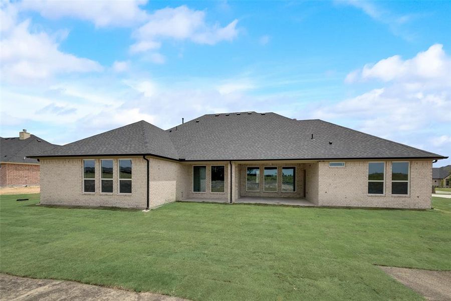 Back of property featuring a patio area and a yard