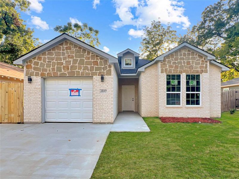 View of front of property with a front lawn and a garage