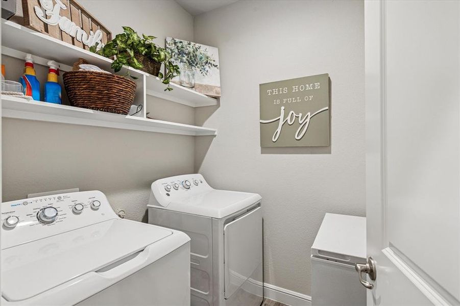 Laundry area featuring shelving for storage, and room for a freezer Laundry area featuring shelving for storage, and room for a freezer