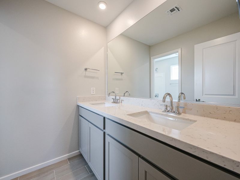 A bathroom with a large mirror. A bathroom with a large mirror.