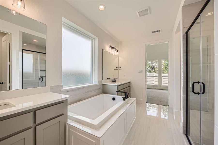 Full bath featuring vanity, a stall shower, a bath, recessed lighting, and marble finish flooring Full bath featuring vanity, a stall shower, a bath, recessed lighting, and marble finish flooring