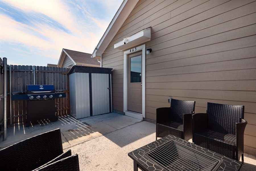 Patio terrace at dusk featuring area for grilling