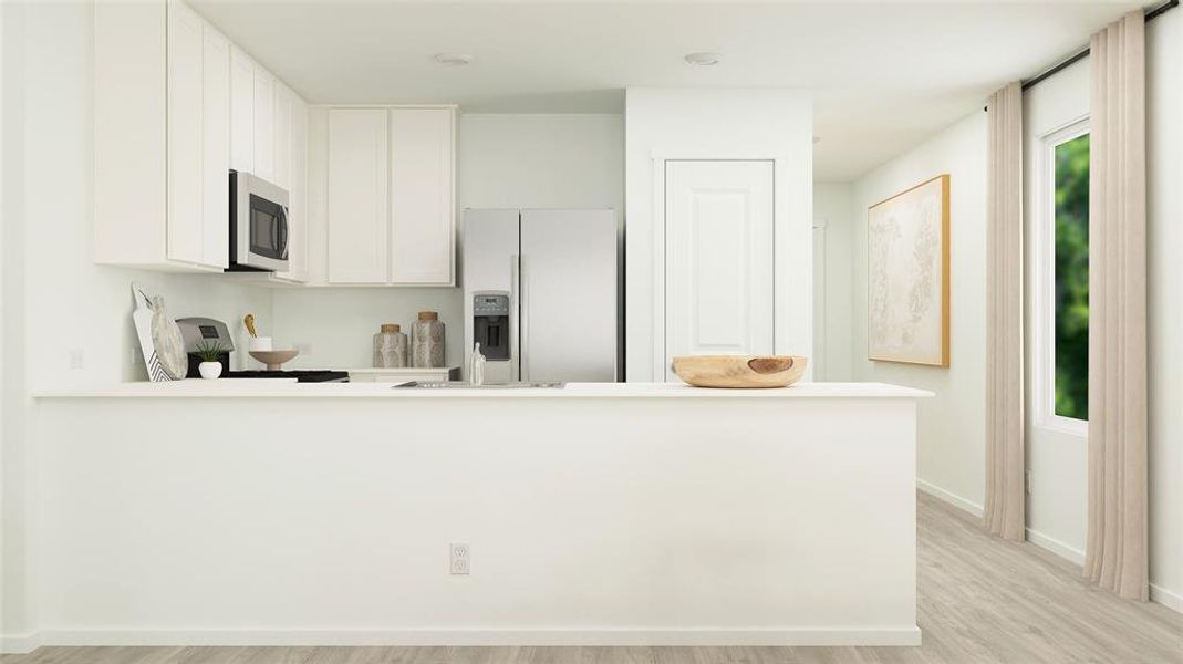 Kitchen featuring white refrigerator with ice dispenser, range, white cabinets, light hardwood / wood-style flooring, and kitchen peninsula