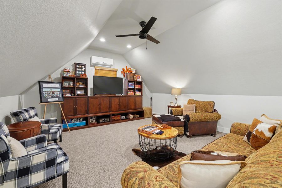 Game room with carpet, lofted ceiling, can lights and ceiling fan