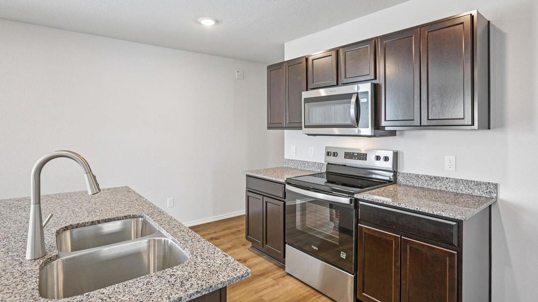 A well-appointed kitchen showcasing contemporary cabinetry and resilient countertops.
