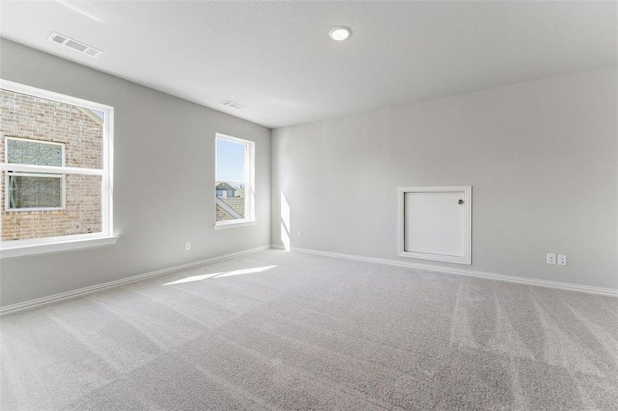 Carpeted spare room with baseboards