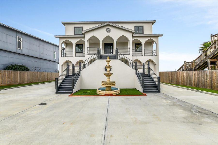 This home makes a statement before you step inside. The elevated Mediterranean-inspired facade, arched details, mature palms, wide private drive and fully fenced setting create an impressive sense of arrival. This home makes a statement before you step inside. The elevated Mediterranean-inspired facade, arched details, mature palms, wide private drive and fully fenced setting create an impressive sense of arrival.