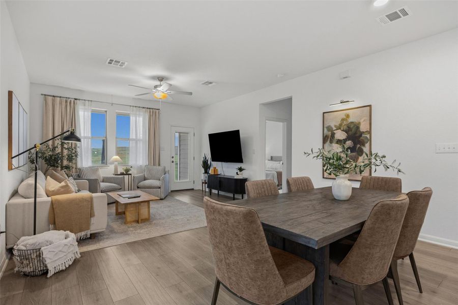 Open-concept living and dining area featuring wood-finish flooring, recessed lighting, and a ceiling fan
