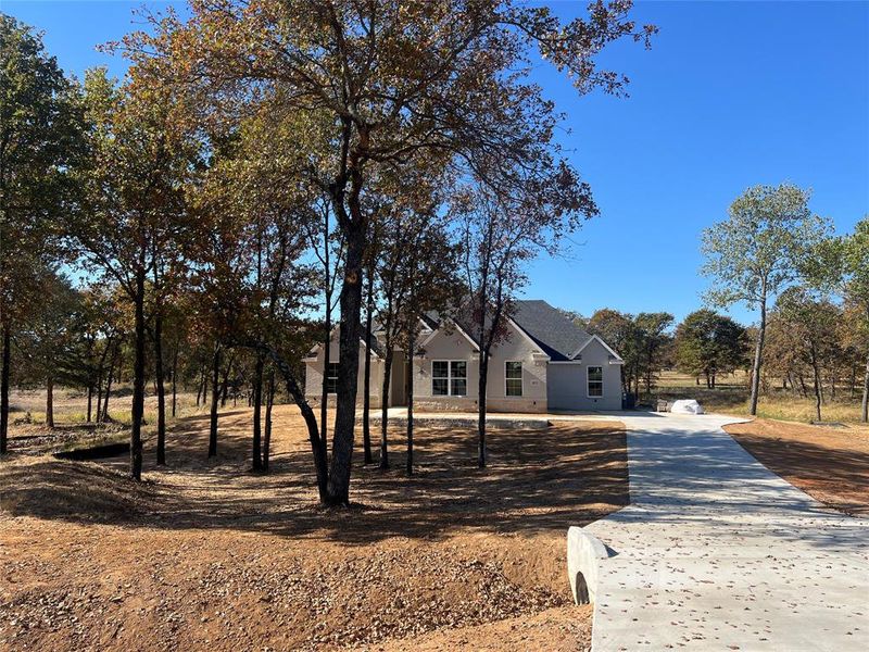 Front exterior of a new home in Escondido Ranches, Poolville, TX, highlighting curb appeal (Image 2).
