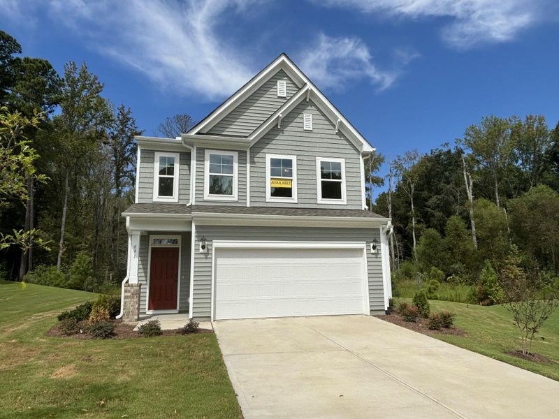 Front exterior of a new home in Daniel Farms, Benson, NC, highlighting curb appeal (Image 1).