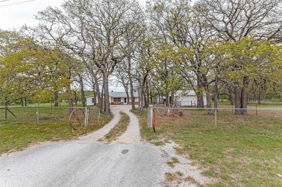 View of dirt / gravel road featuring a gated entry View of dirt / gravel road featuring a gated entry