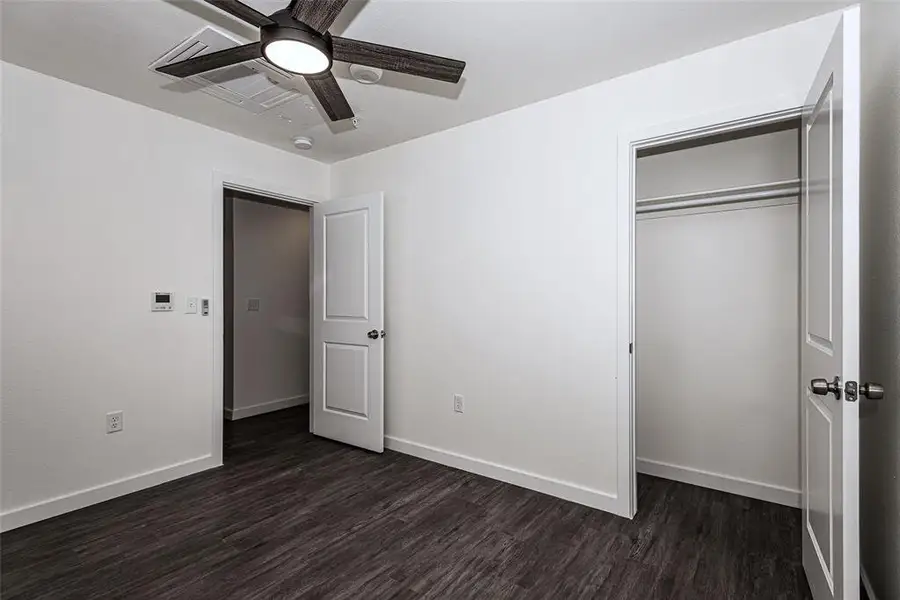 Primary Bedroom1 with a closet, ceiling fan, and wood-type flooring