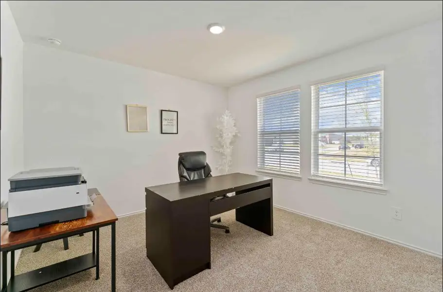 This versatile bedroom, located at the entrance, is currently set up as a bright, functional office space. This versatile bedroom, located at the entrance, is currently set up as a bright, functional office space.