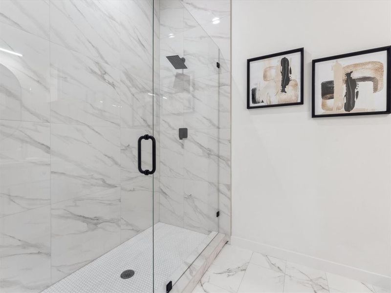 Bathroom with a marble finish shower, marble finish floor, and baseboards