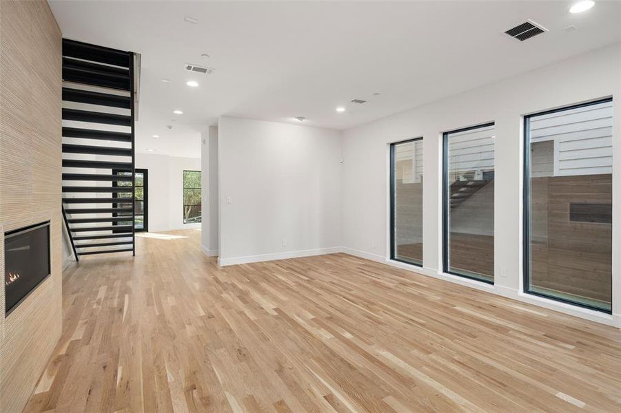 Unfurnished living room featuring light wood-type flooring