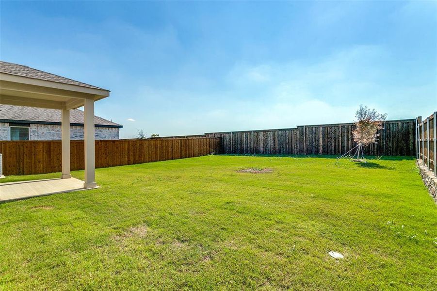 Exterior details and patio area of a home in The Preserve, Justin (Image 21).
