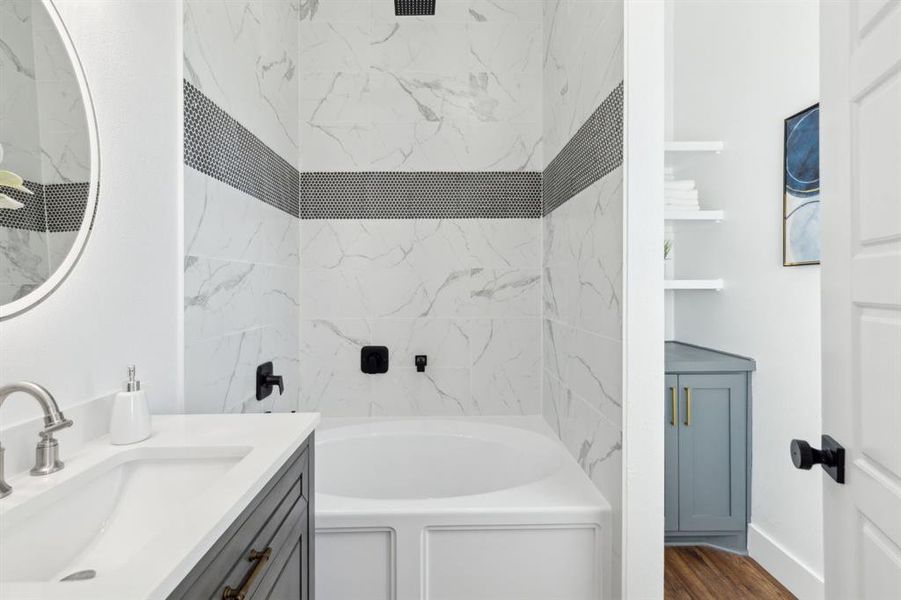 Full bathroom with a tub-shower combo and extra storage. Full bathroom with a tub-shower combo and extra storage.