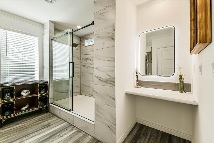 Master bath vanity area w/ stylish back-lit mirror