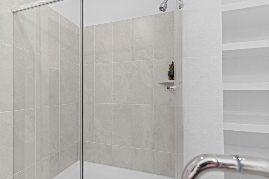 Another view of the stunning massive walk-in shower shows off its generous size, tiled walls, and built-in niche, ideal for storing your favorite bath products. Never run out of hot water with the Tankless/On-Demand H2O Heater! **Image Representative of Plan Only and May Vary as Built**. Another view of the stunning massive walk-in shower shows off its generous size, tiled walls, and built-in niche, ideal for storing your favorite bath products. Never run out of hot water with the Tankless/On-Demand H2O Heater! **Image Representative of Plan Only and May Vary as Built**.