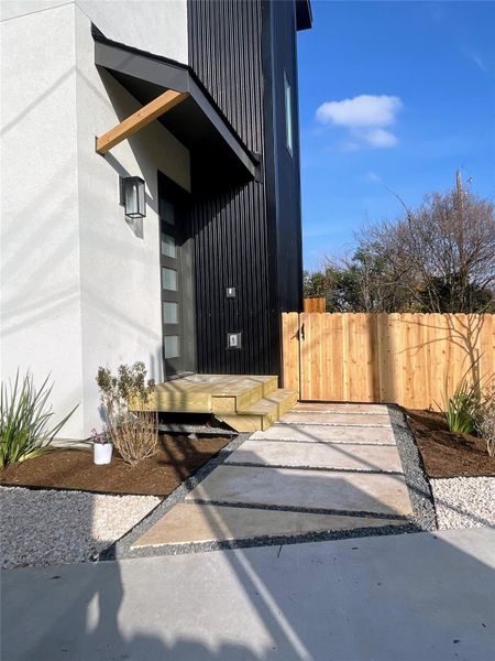 View of side of property with a gate