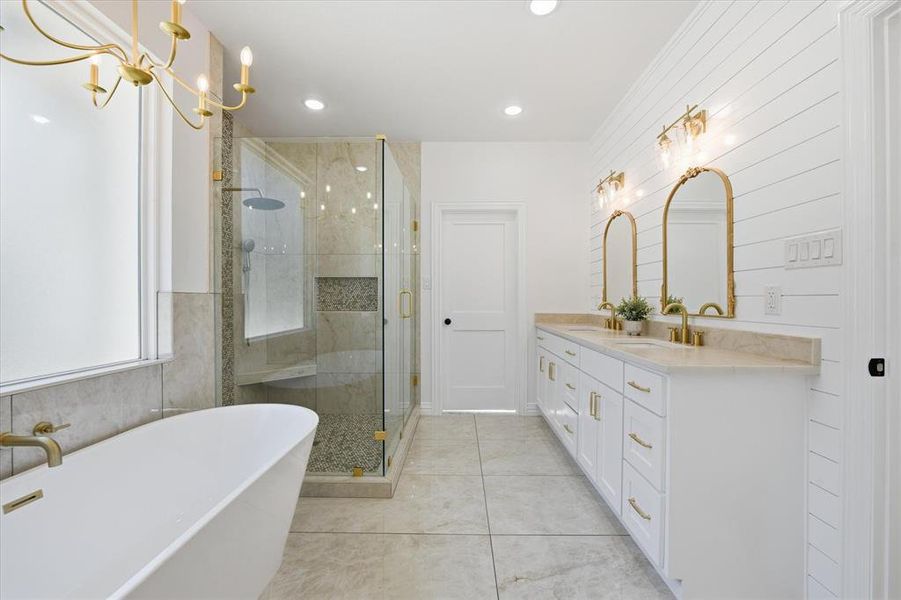 Full bathroom with double vanity, a soaking tub, a stall shower, recessed lighting, and light tile patterned floors
