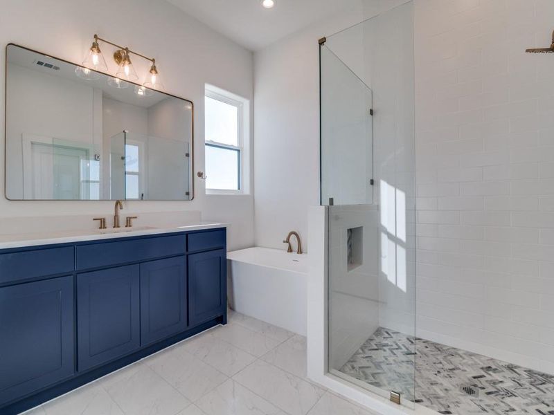 Bathroom featuring a soaking tub, vanity, a shower stall, light marble finish flooring, and recessed lighting