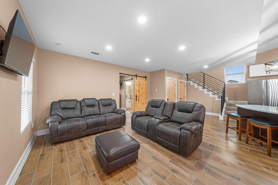 This living room is a masterclass in "Modern Rustic" design, perfectly blending cozy warmth with high-end finishes. It’s an open-concept space that feels both expansive and incredibly inviting.