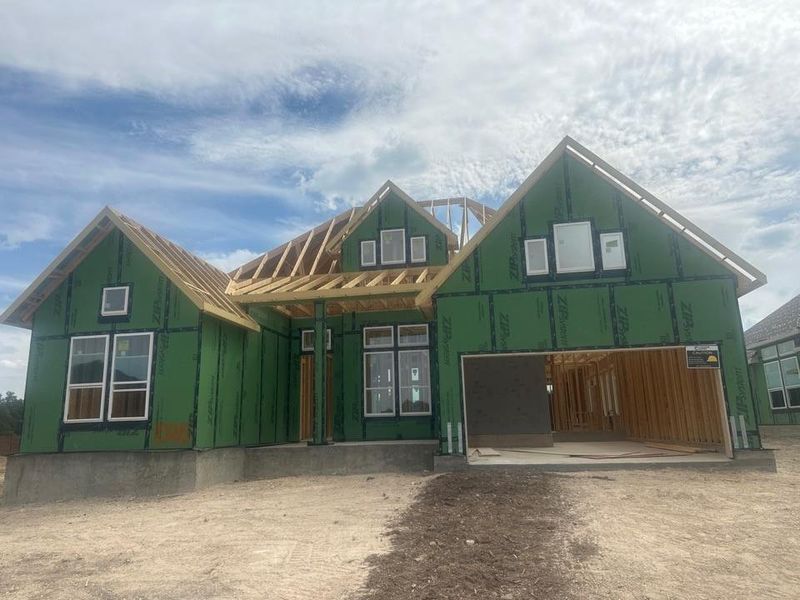Unfinished property with a standing seam roof, a metal roof, and covered porch Unfinished property with a standing seam roof, a metal roof, and covered porch