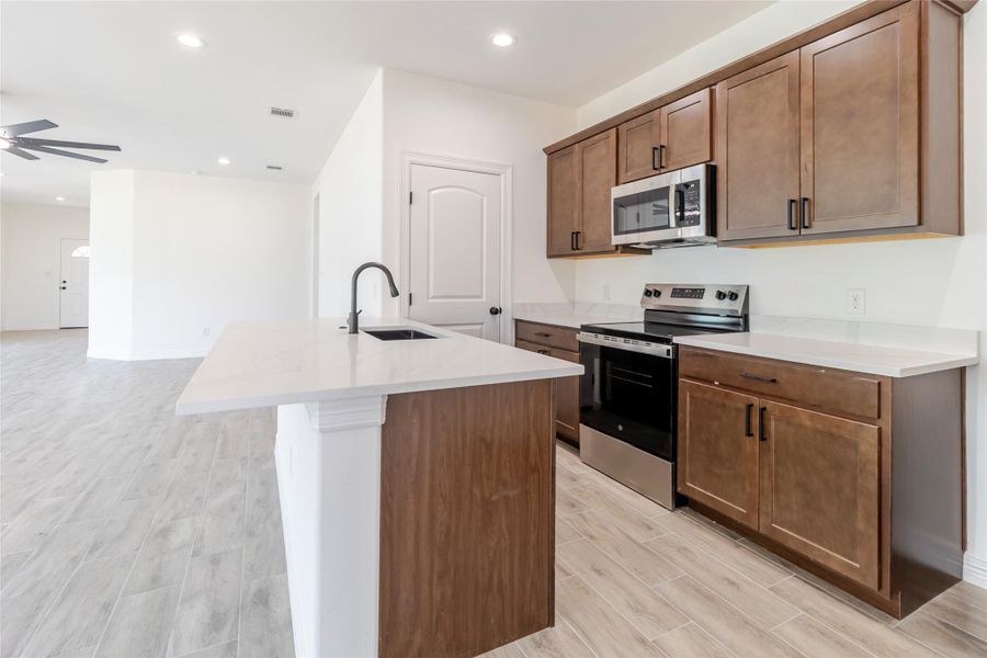 The breakfast bar keeps the kitchen in the conversation while leaving a clear lane for cooking and prep. The breakfast bar keeps the kitchen in the conversation while leaving a clear lane for cooking and prep.