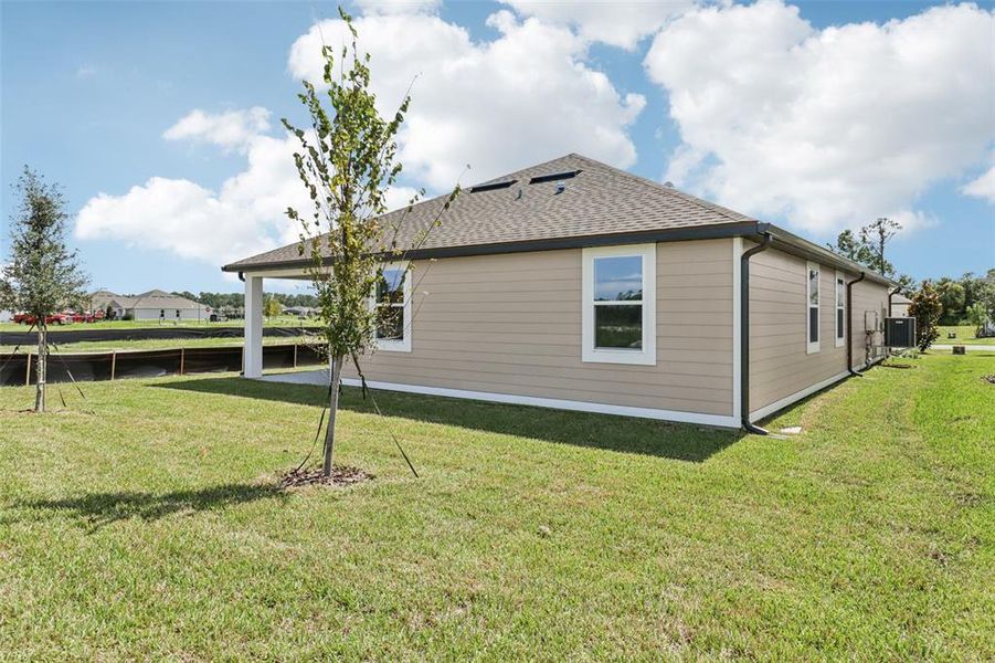 Exterior details and patio area of a home in Ardisia Park, New Smyrna Beach (Image 24).