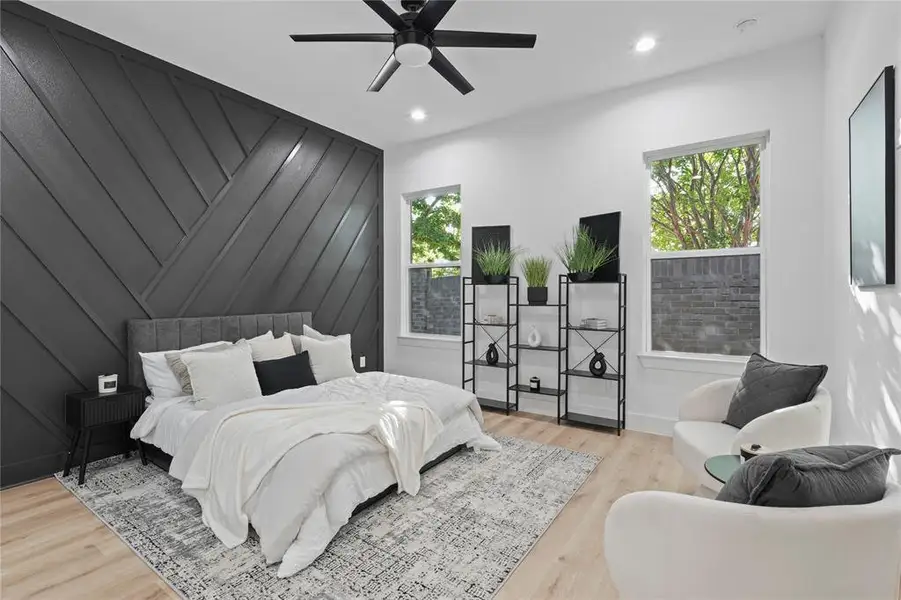 Bedroom with multiple windows, wood finished floors, recessed lighting, and a ceiling fan