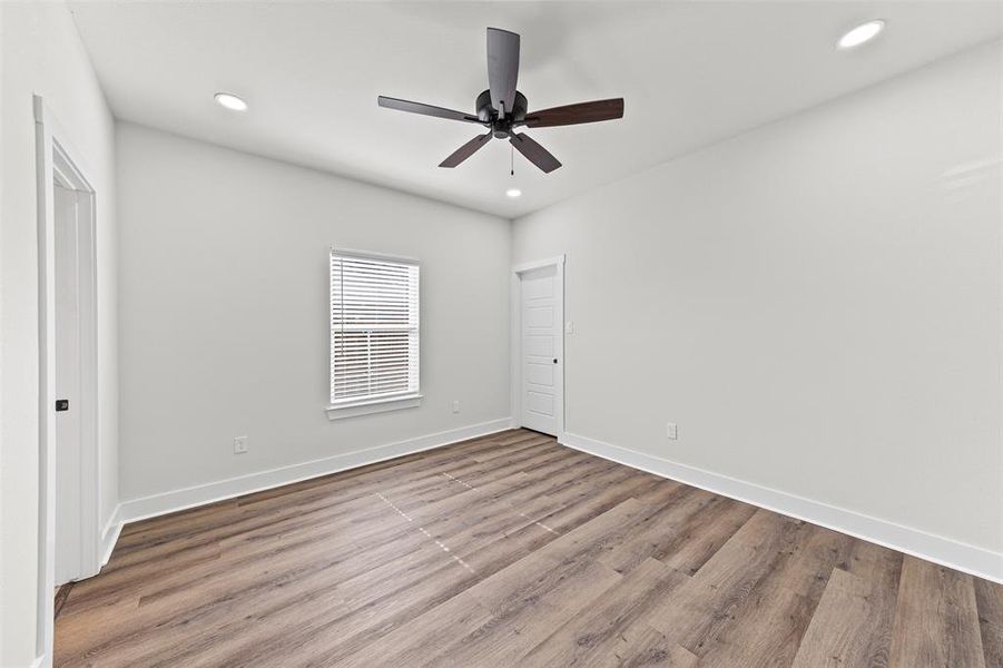 Unfurnished bedroom with wood finished floors, ceiling fan, and recessed lighting Unfurnished bedroom with wood finished floors, ceiling fan, and recessed lighting