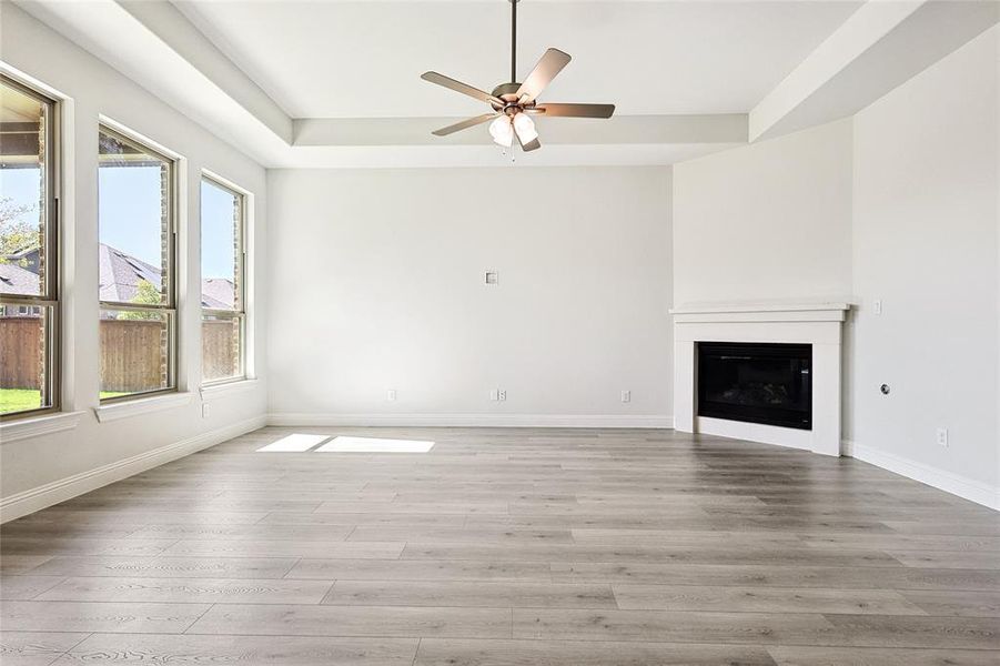 Unfurnished living room featuring light hardwood / wood-style floors and ceiling fan