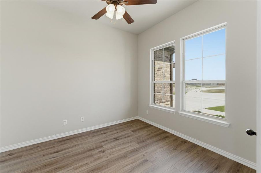 Unfurnished room featuring light wood-type flooring and ceiling fan Unfurnished room featuring light wood-type flooring and ceiling fan