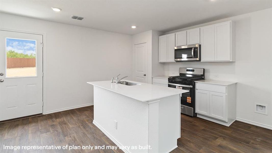 Kitchen featuring stainless steel appliances, white cabinets, a center island with sink, dark wood-style flooring, and recessed lighting