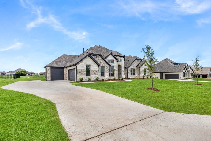 Front exterior of a new home in Heritage, McLendon-Chisholm, TX, highlighting curb appeal (Image 15).