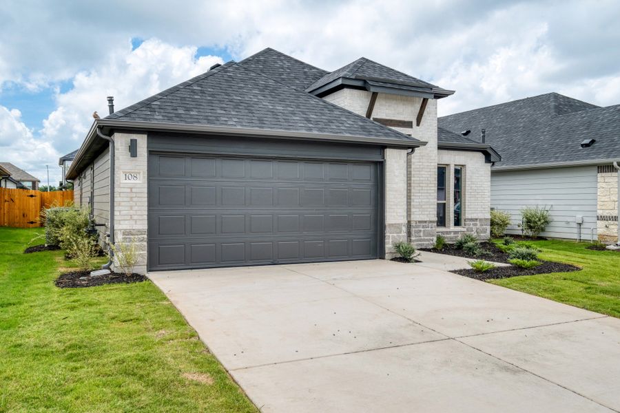 Front exterior of a new home in Prairie Winds, Hutto, TX, highlighting curb appeal (Image 18). Front exterior of a new home in Prairie Winds, Hutto, TX, highlighting curb appeal (Image 18).