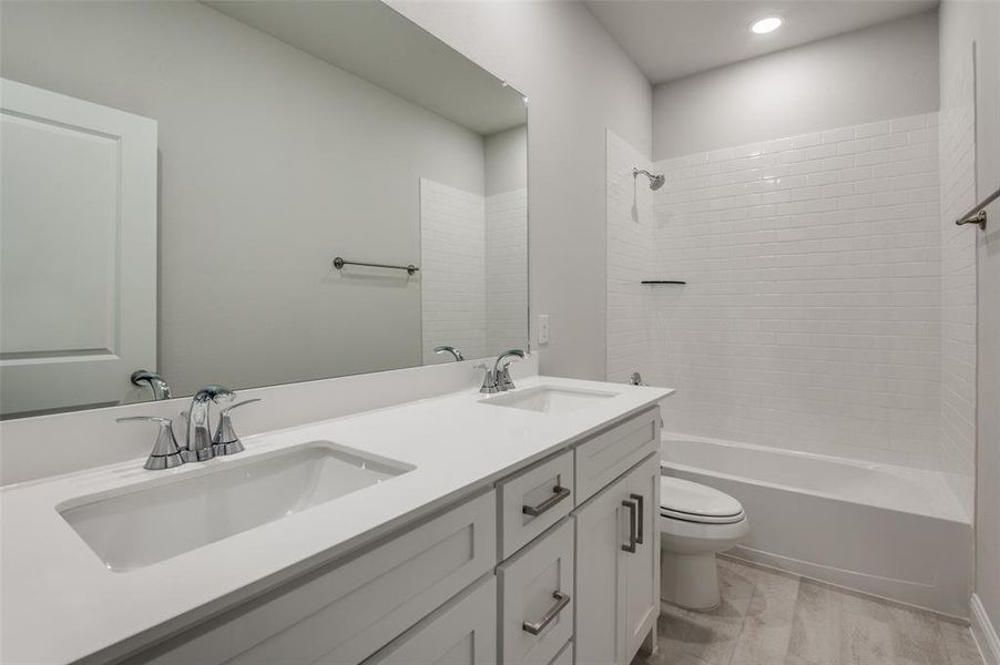 Full bathroom featuring toilet, wood-type flooring, vanity, and tiled shower / bath